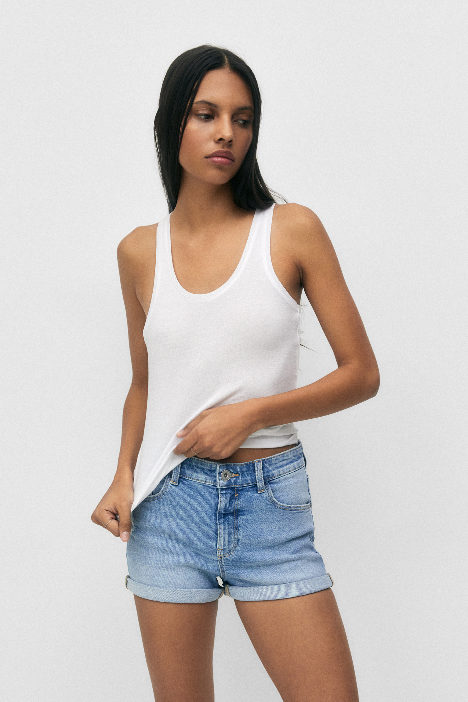 Woman Outside in White Cropped Tank Top and Jean Shorts Stock Photo | Adobe  Stock
