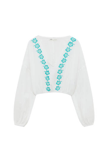 White embroidered floral blouse