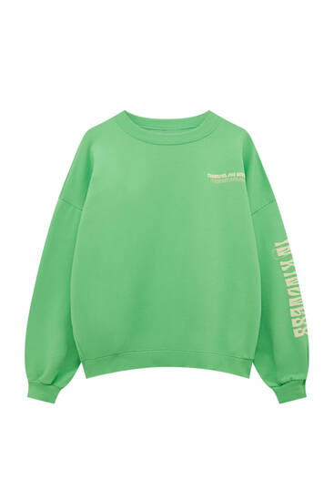 Green sweatshirt with sleeve graphic