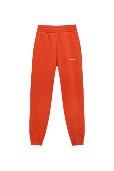 Kolorowe polarowe spodnie jogger z napisem