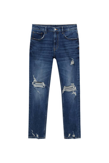 Jeansy skinny z tkaniny premium z przetarciami