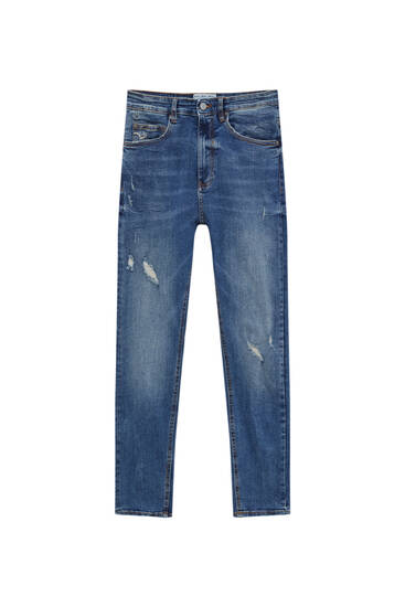 Carrot fit jeans with rips on the leg 