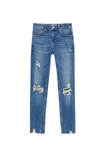 Úzké džíny z prémiové látky s detailem roztrhání