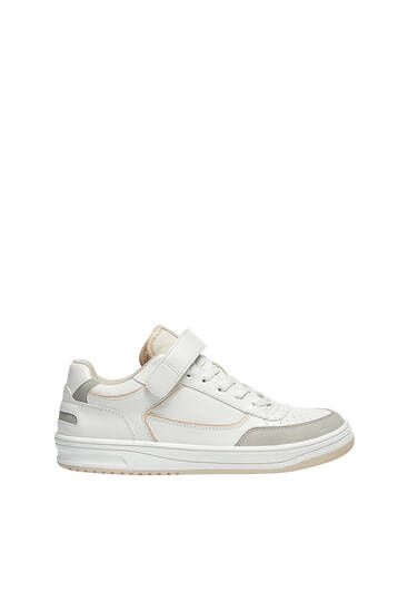 Casual trainers with adhesive strap