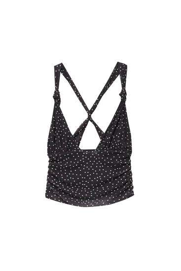 Polka dot strappy top with a crossover back