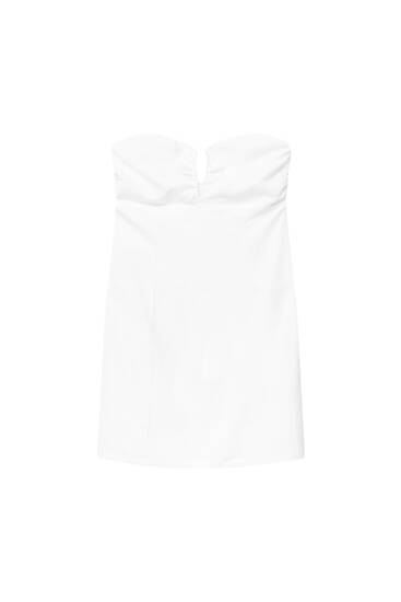 Korte en witte jurk in korsetlook