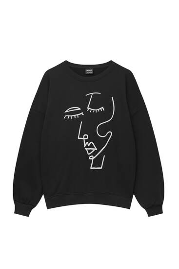 Black sweatshirt with face graphic