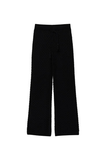 Open-knit trousers with tassels