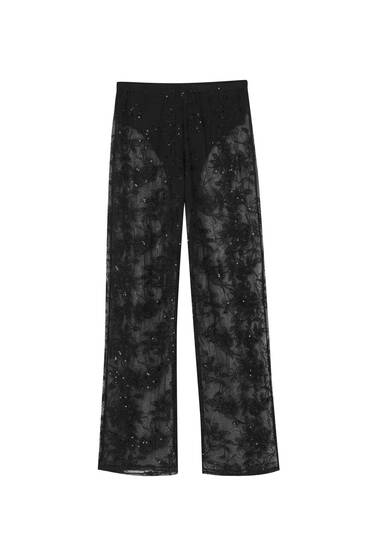 Flowing sequinned lace-trimmed trousers