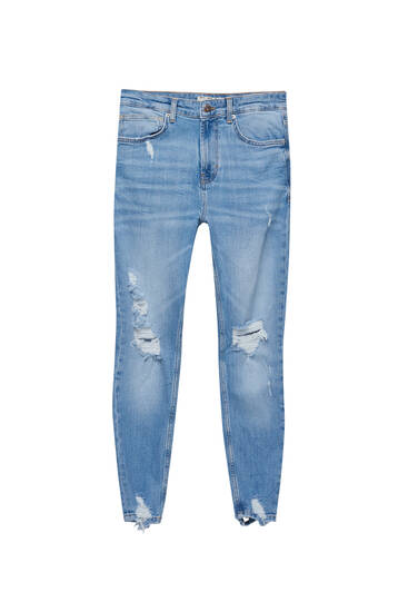 Jeans skinny tessuto premium con strappi
