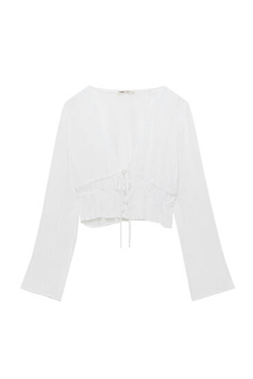 White blouse with flared sleeves