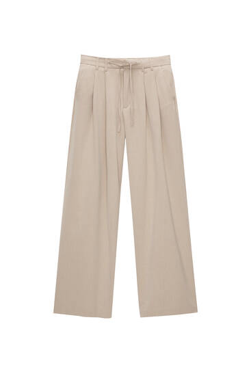 Flowing pinstripe trousers with darts