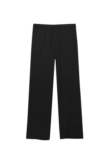 Flowing trousers with elastic waistband