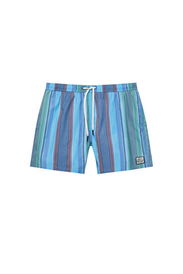 Swimming trunks with blue stripes and STWD label