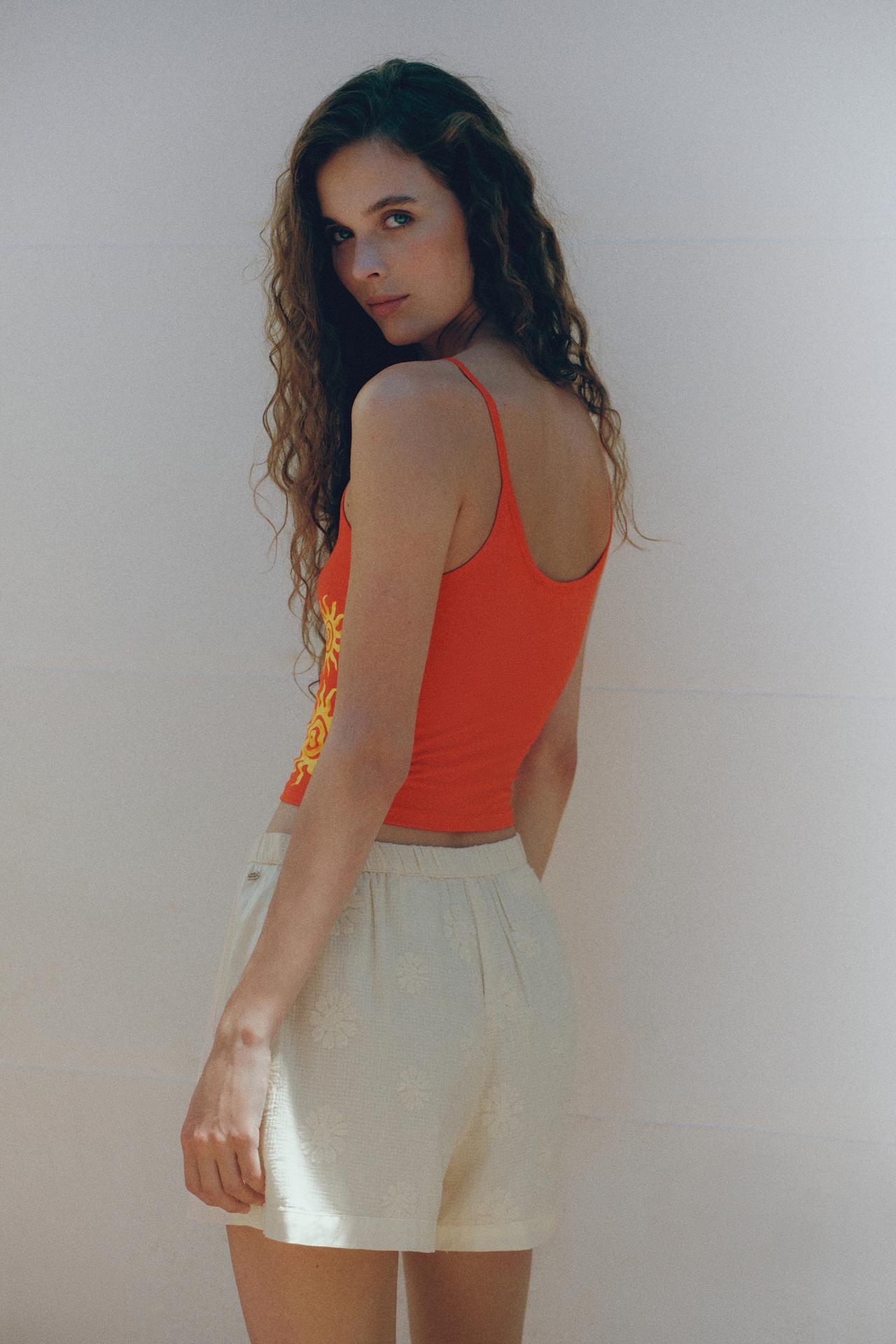 Orange sun graphic top — Red
