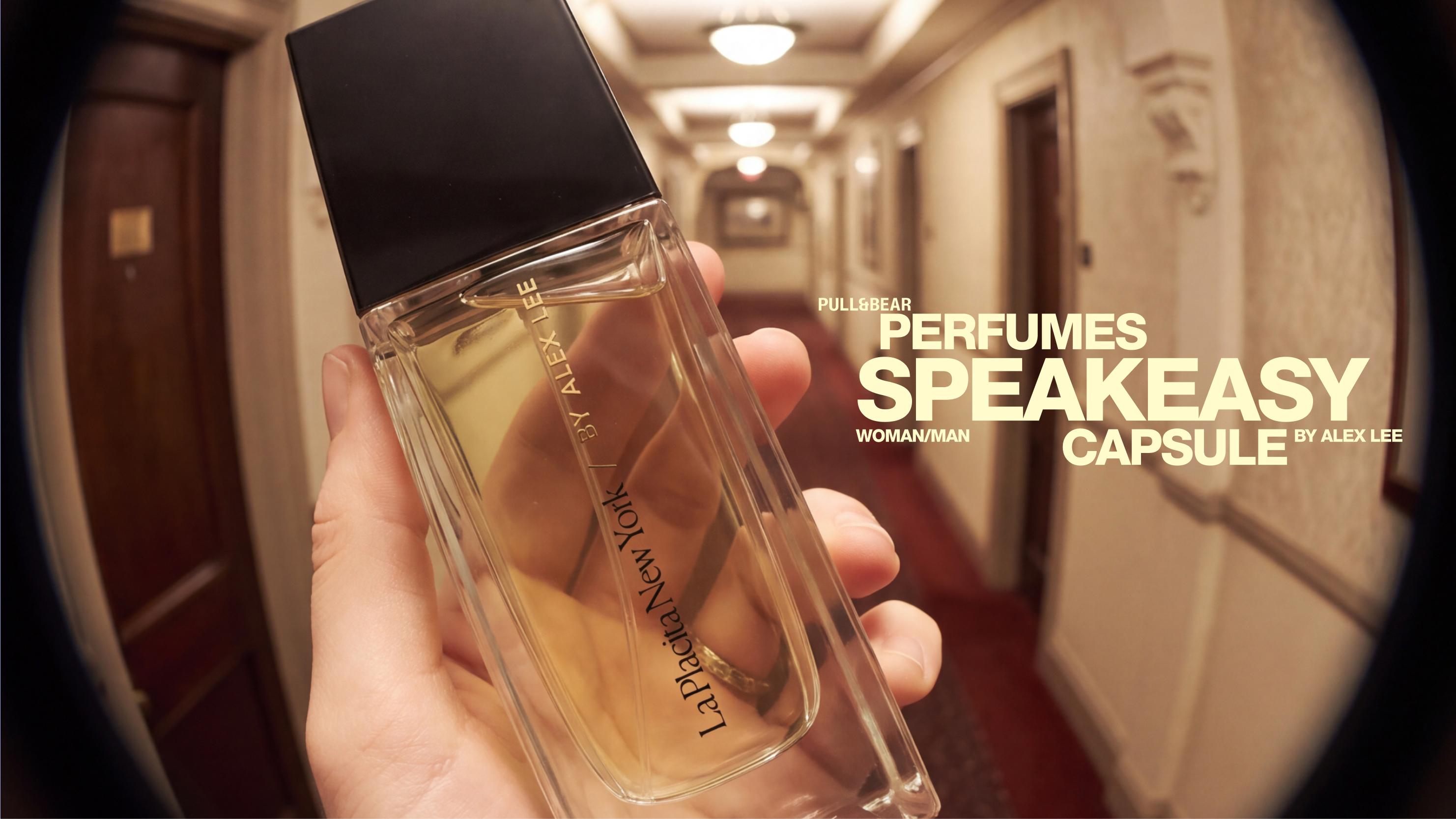 Hand holding perfume in corridor. Text: La Placita New York / BY ALEX LEE PULL&BEAR PERFUMES SPEAKEASY WOMAN/MAN CAPSULE BY ALEX LEE