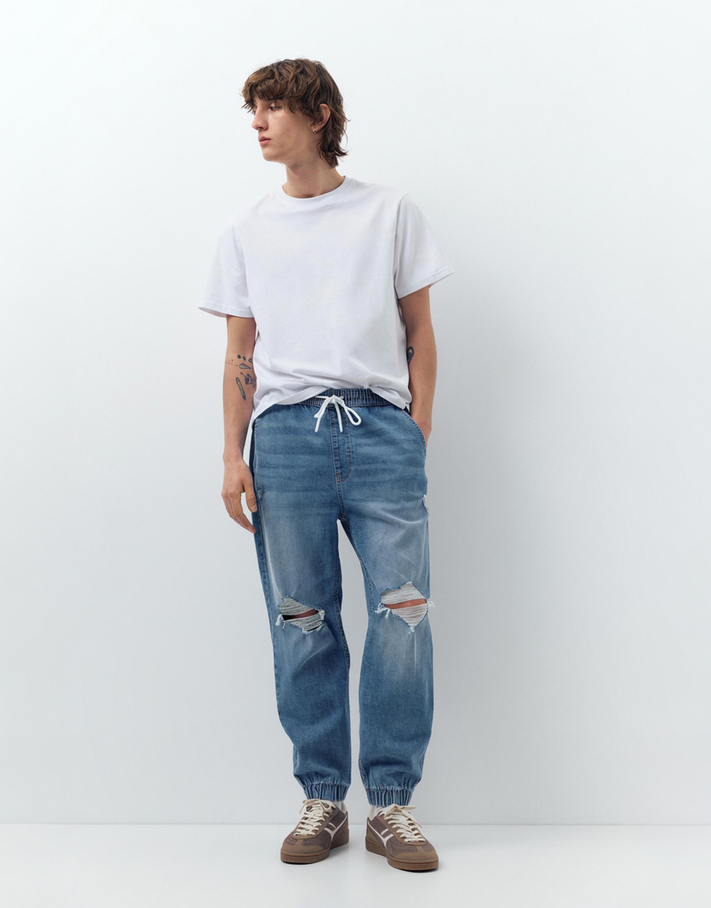 Ripped denim jogger trousers — Pale indigo