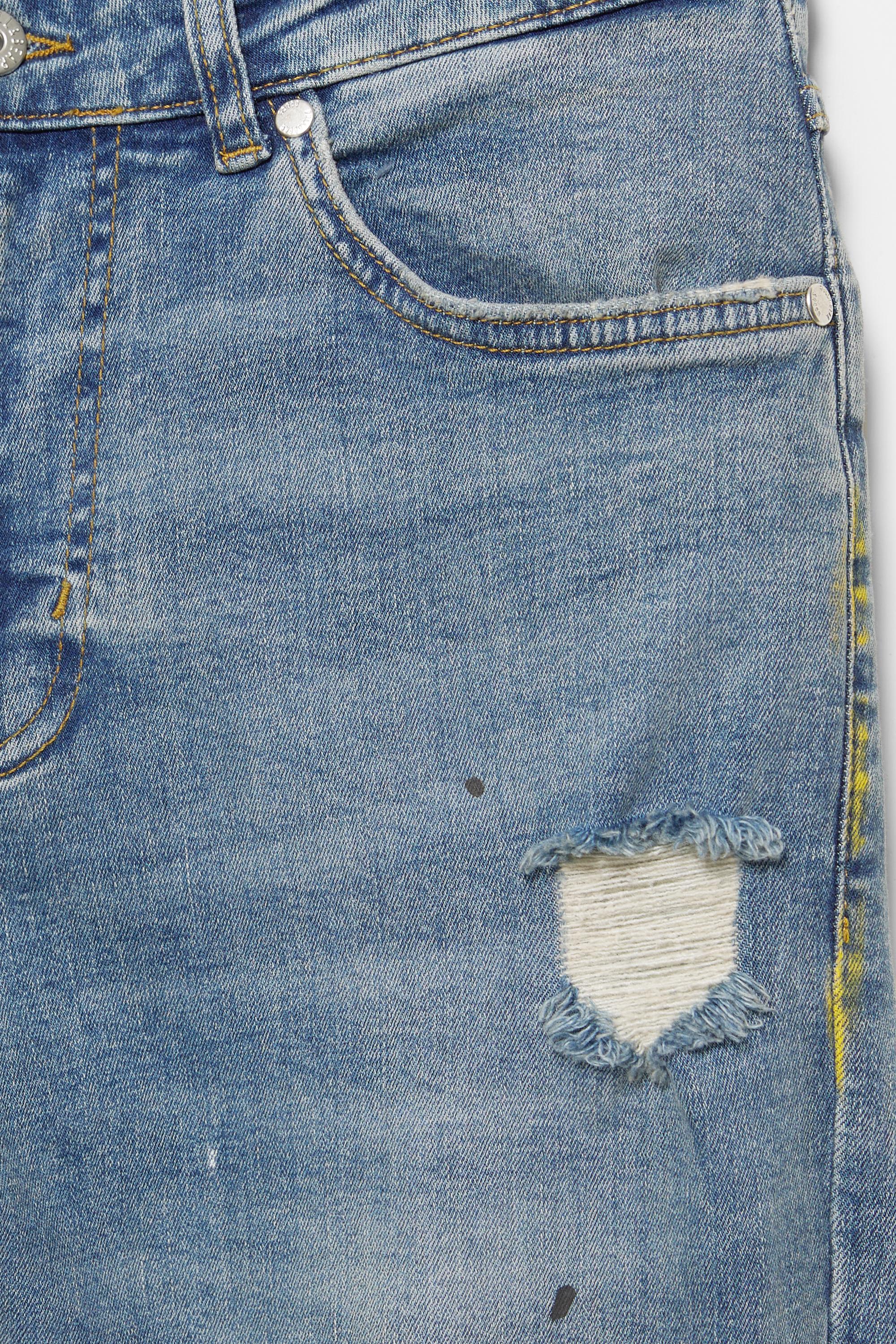 Paint splatter carrot-fit jeans — Medium blue