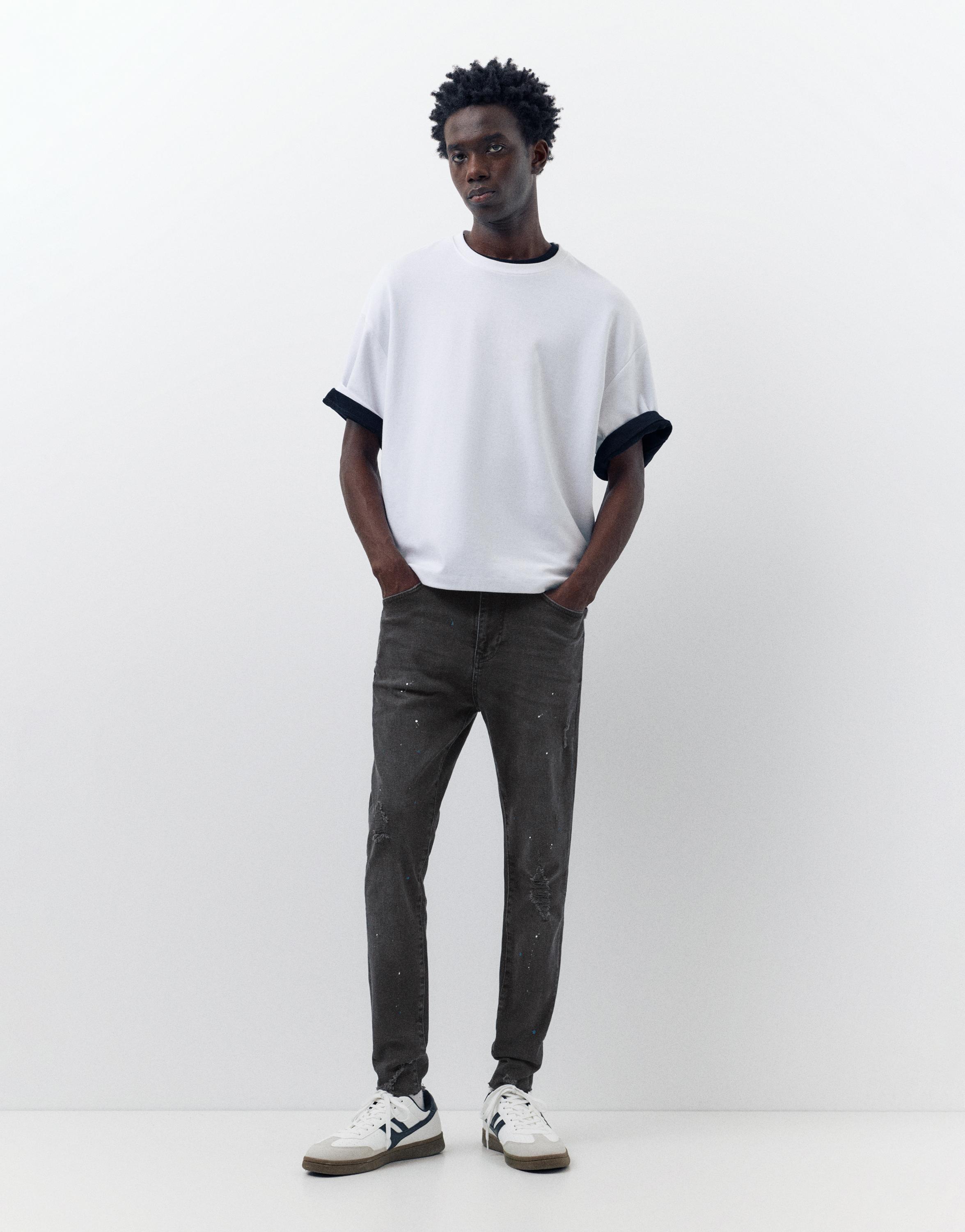 Paint splatter carrot-fit jeans — Faded black