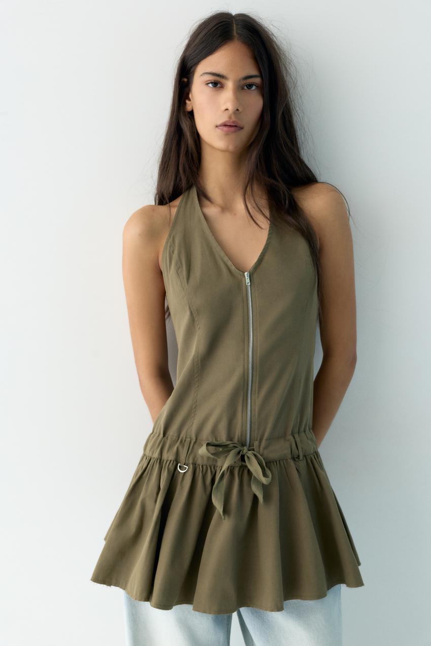 Khaki short halterneck dress set with front zip, waist tie and voluminous hem.