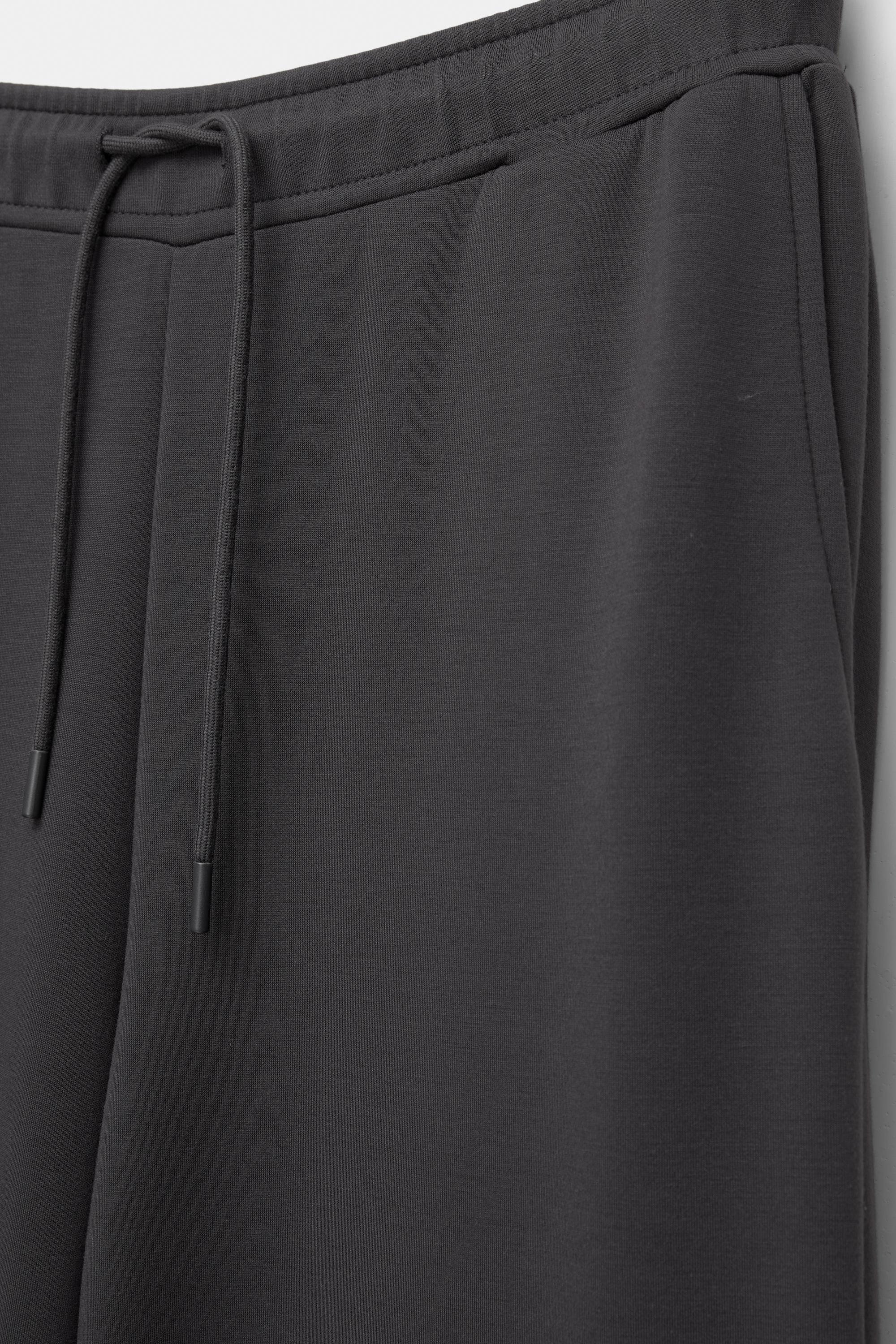 Soft-touch wide-leg trousers — Black
