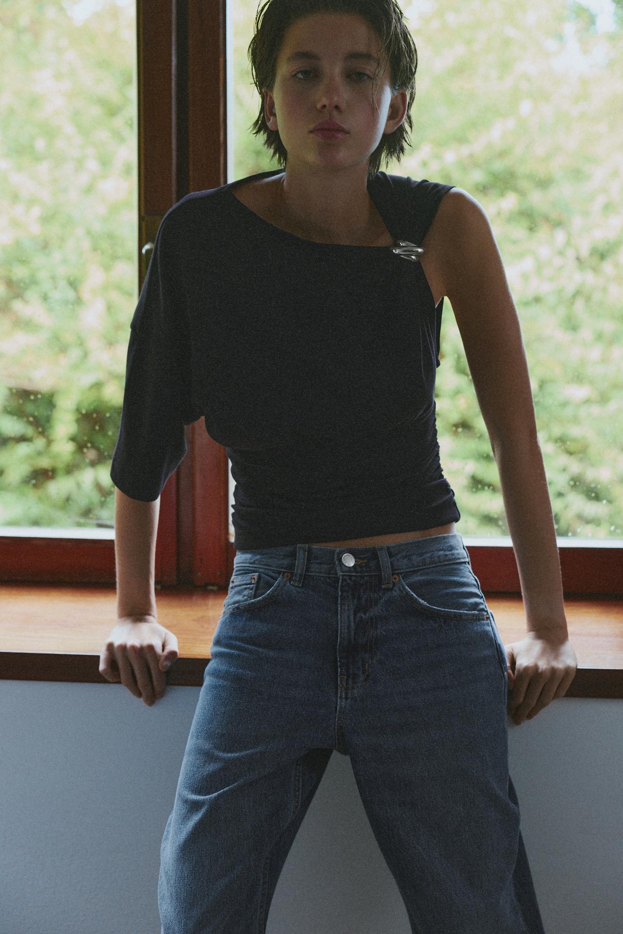 Asymmetric appliqué top — Black